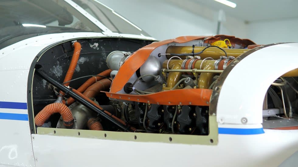 Open engine bay inside a piston aircraft hangar